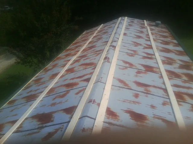 Rusted metal roof panels with new wood purlins before replacement — Storm Damage Roof Repair in Waldo by Roofing Brothers